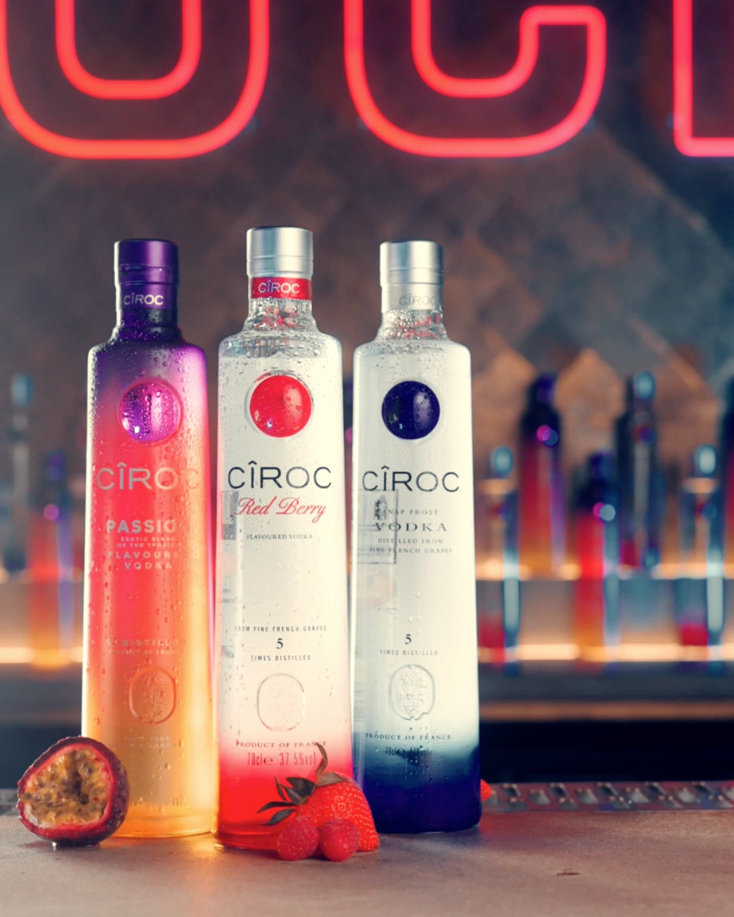 Three CÎROC bottles on the bar at Rock City under the neon sign