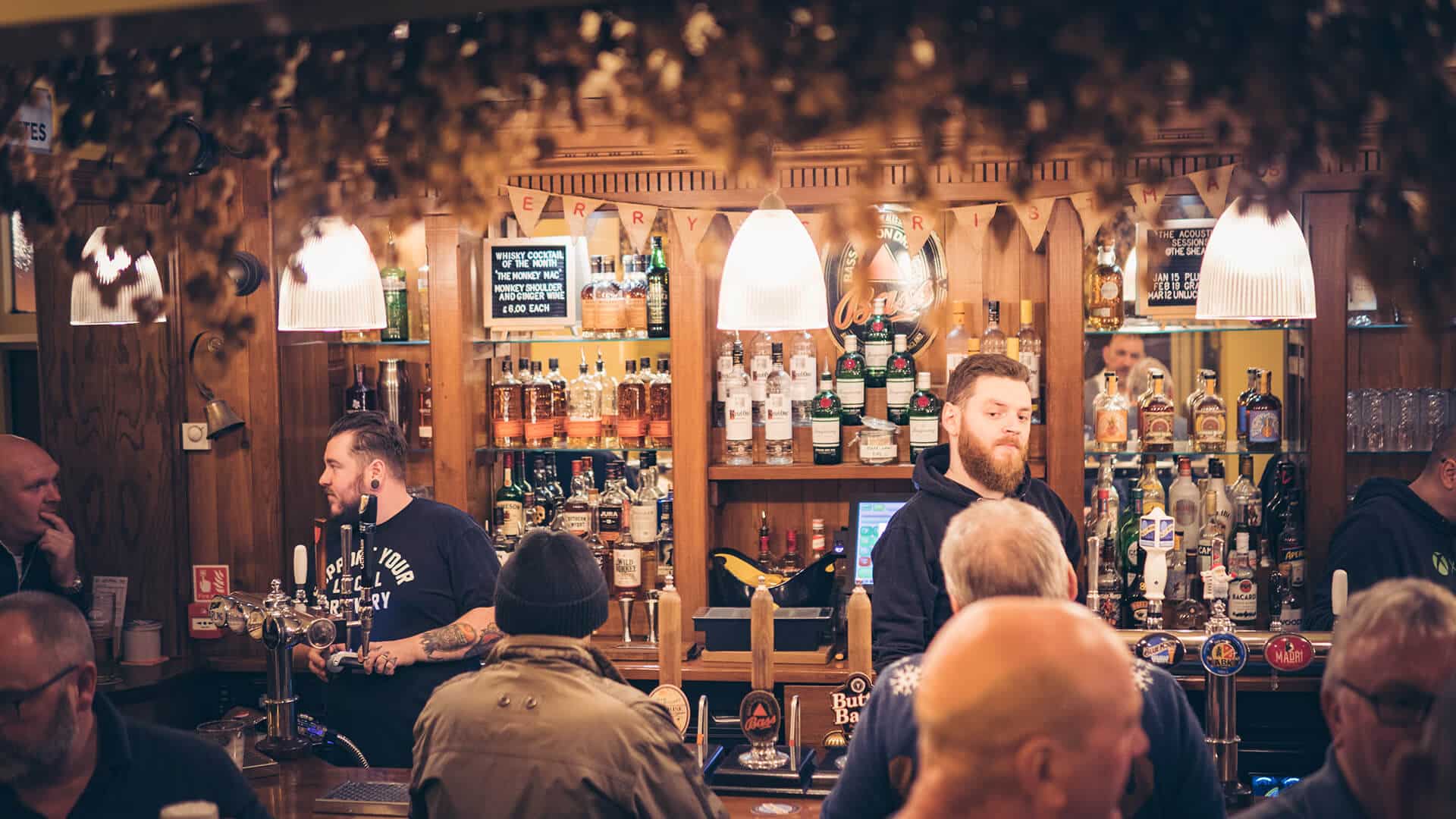 Banner image for the blog post 'Recruiting Against the Grain,' featuring Coldmore Taverns, showcasing a laptop with marketing insights and strategies for talent recruitment in the hospitality sector.